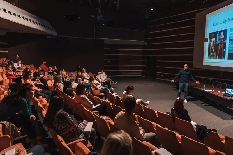 Fitness professionals attending an HFS education seminar in a large lecture hall